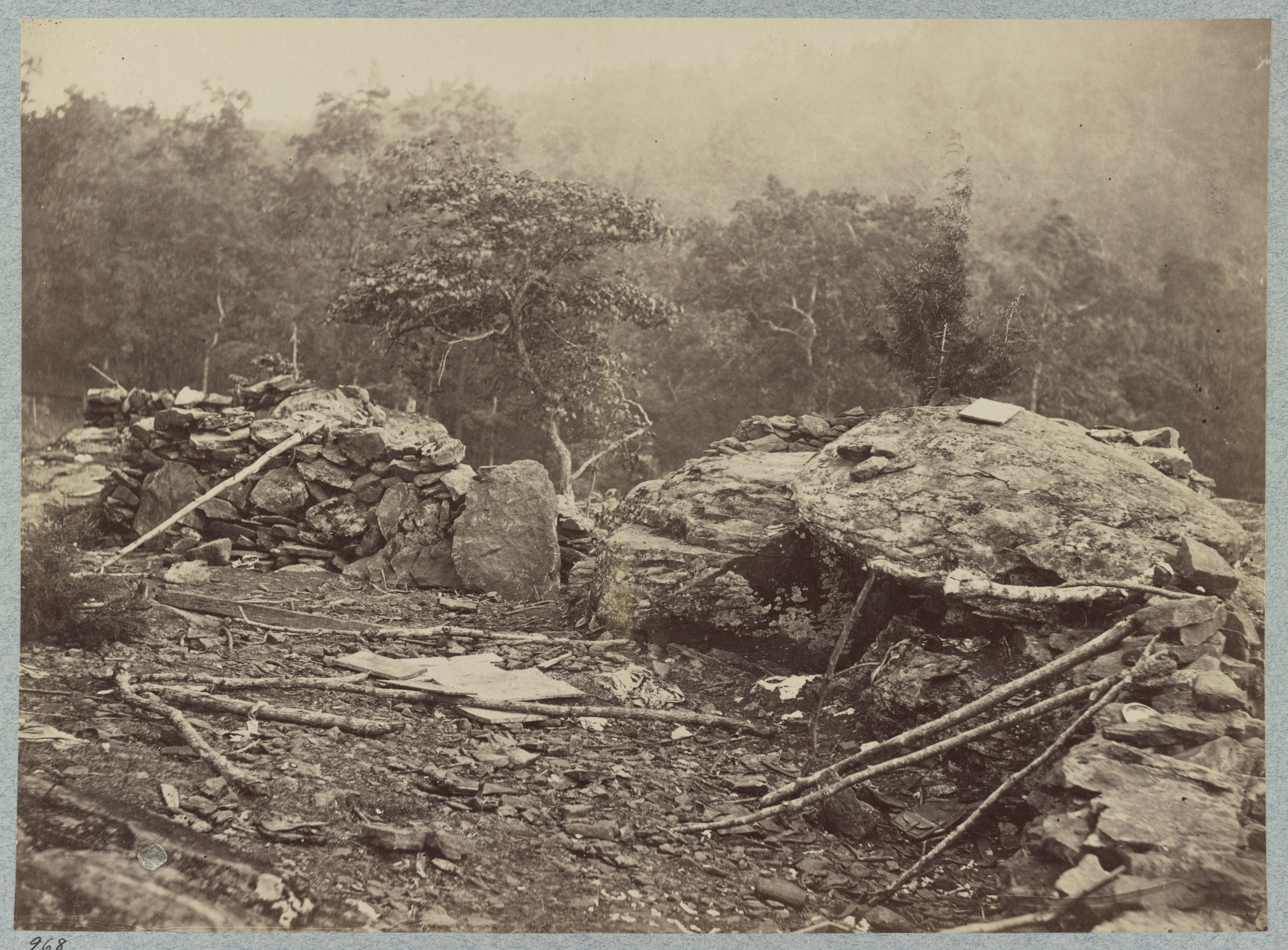 Rough stone and log entrenchments on the slope of Little Round Top at Gettysburg, with Big Round Top rising in the background, 1863